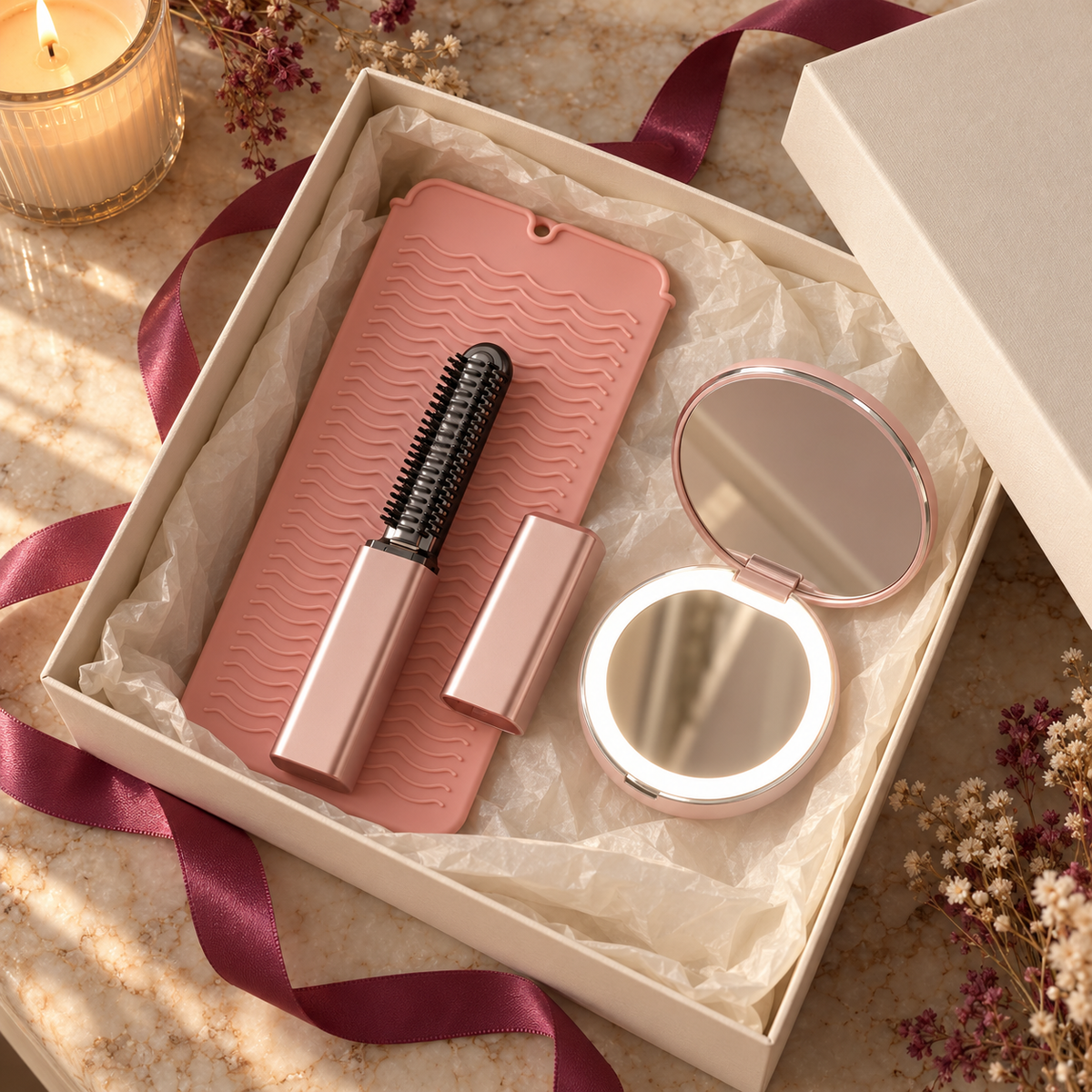 Oaklo Touch-Up Kit in an open cream gift box: Rose Portable Mini Hair Styler, blush pink Mini Heat-Safe Pouch and rose Portable Mini LED Mirror with a berry ribbon